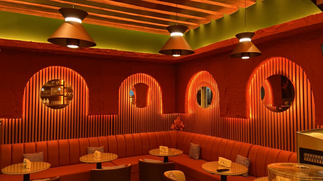Inside SUNLIFE: warm arched booths and wood ceiling